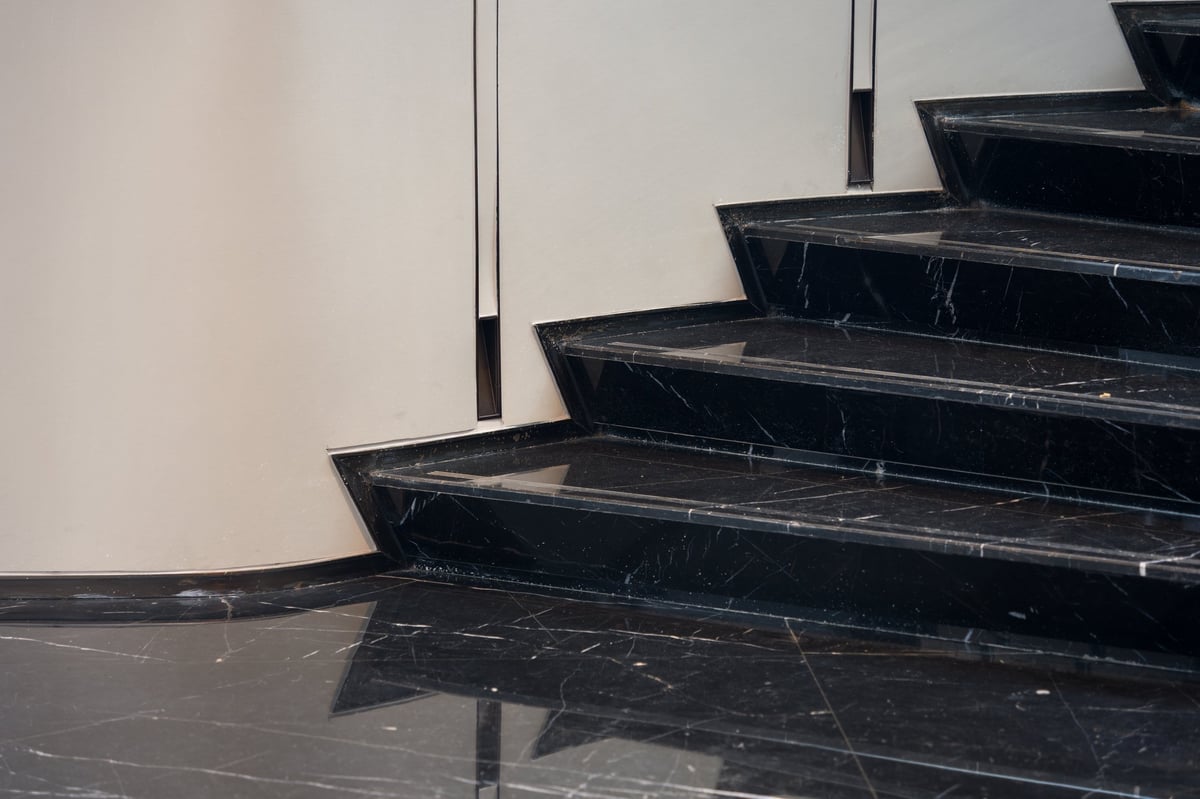 Curved marble staircase with a polished stone finish, restored by Marble Best